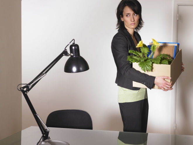 Woman with office furniture in a box